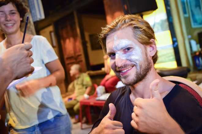 Foreign tourists enjoy face painting service in Hanoi, Hanoi old quarter, Ma May Street, walking street pedestrian streets