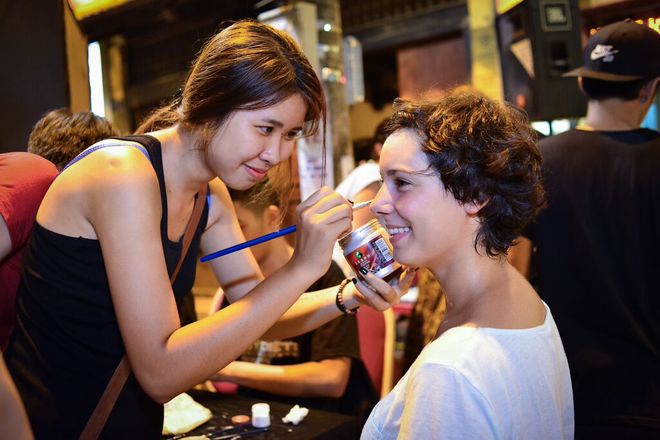 Foreign tourists enjoy face painting service in Hanoi, Hanoi old quarter, Ma May Street, walking street pedestrian streets